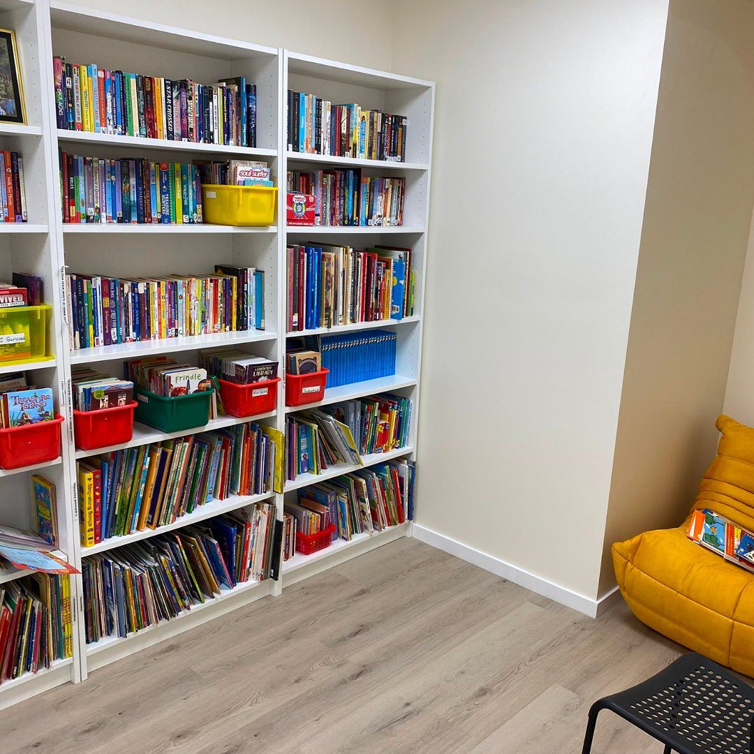 School library shelving and yellow reading seat