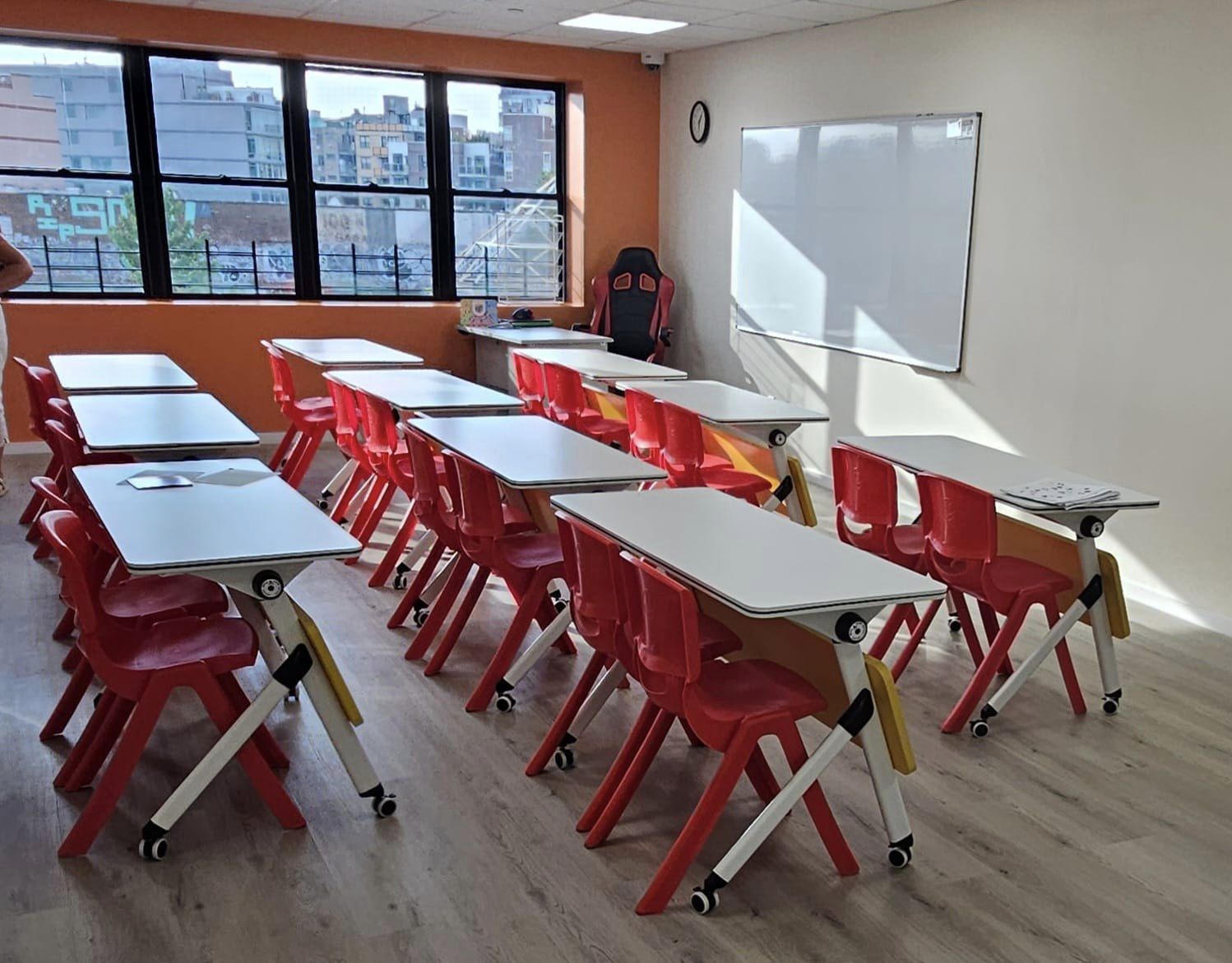 New York classroom with red chairs and white desks